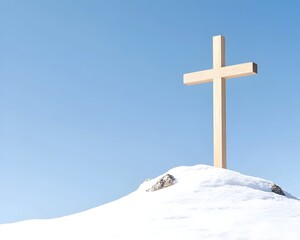 A simple wooden cross stands atop a snow-covered hill against a clear blue sky