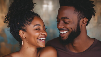 Young African-American couple laughing sincerely together on bright background