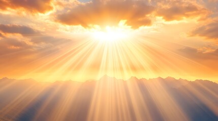 Radiant sunrise illuminates mountainous landscape with sun rays piercing through clouds