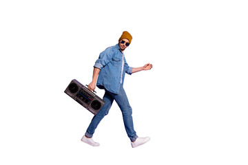 Full length body size profile side photo of carefree moving attractive handsome guy holding sound recorder with hands going to discotheque isolated over purple bright color background