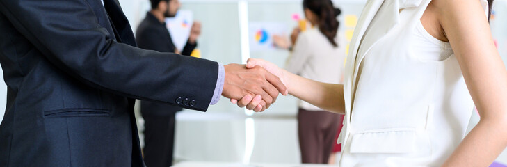 closeup of business partners shaking hands after concluding a business finished. Businessman and...