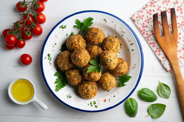 Fried chickpea falafel balls with parsley sprigs.