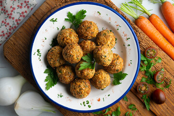 Fried chickpea falafel balls with parsley sprigs.