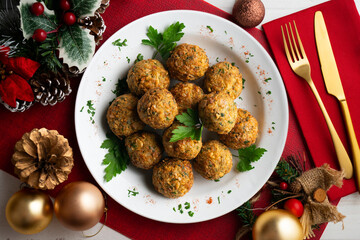 Fried chickpea falafel balls with parsley sprigs. Top view table with christmas decorations.