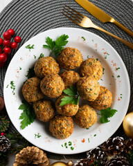 Fried chickpea falafel balls with parsley sprigs. Top view table with christmas decorations.
