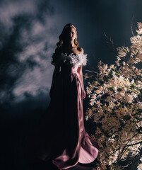 art photo real person fantasy woman walking through branches in saint divine light ray in black...