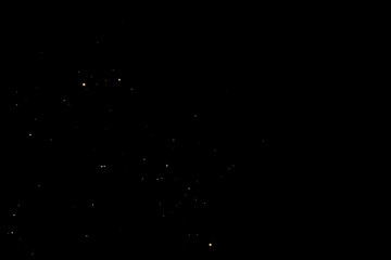 Small golden light particles scattered on dark background, dreamy night sky with sparkling stars, fantasy mood