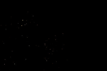 Small golden light particles scattered on dark background, dreamy night sky with sparkling stars, fantasy mood