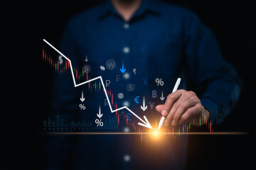 Businessman analyzes falling currency values ​​on stock market candlesticks. Concept of...