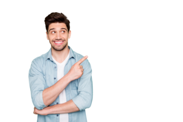 Photo of amazing salesman guy in excited mood indicating finger to empty space advising cool shopping prices wear casual denim shirt isolated green color background