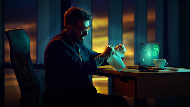 Emotional, angry businessman sitting in dark office, tearing financial reports , feeling frustrated about professional collapse. Concept of business, crisis, failure, leadership, market downturn