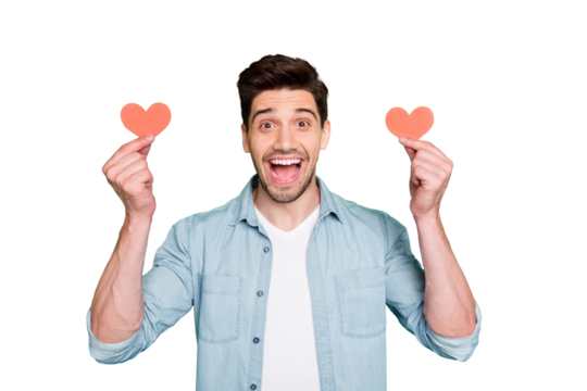 Photo of amazing guy holding two little red paper hearts overjoyed taking cool creative prom invitation wear denim shirt isolated green color background