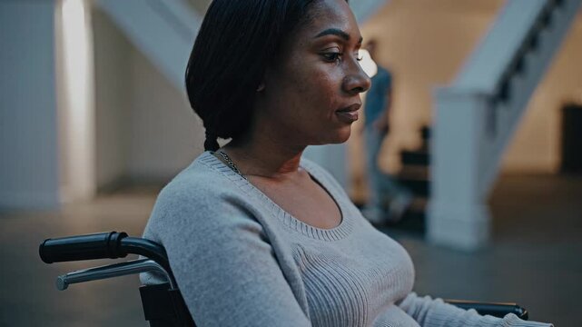 Focused determination: woman in wheelchair navigating home environment with purpose