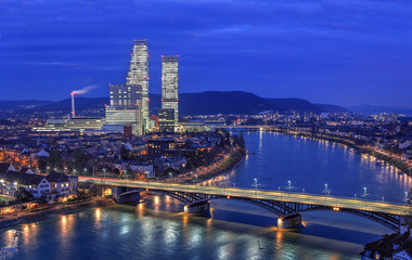 Night cityscape of the Swiss city Basel over the Rhine river with street lights and high rise buildings © Siyue