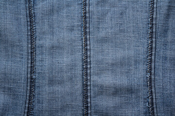 Naklejka premium Close-up of overlock seams on the reverse side of denim fabric