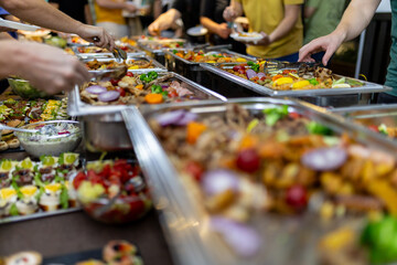Buffet spread featuring a variety of dishes served at a social gathering in the evening