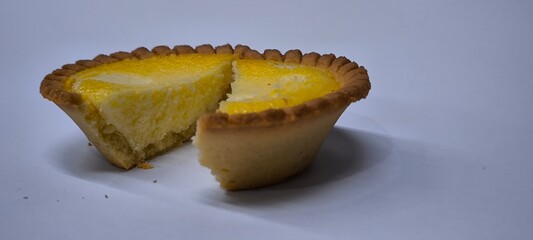 Egg tarts that are crispy on the outside and soft on the inside. Egg tarts that have a rich and creamy egg aroma. Egg tarts on white background.