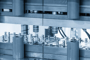 The metal forming process by progressive die in the light blue scene.
