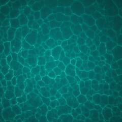 An aerial view of sunlight reflecting off the clear sea