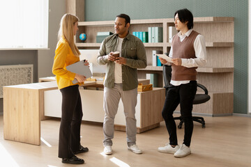 Multi ethnic business team discussing during coffee break in office