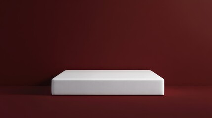 Luxurious pure white foam mattress standing against a sleek dark red background