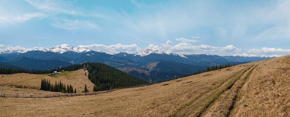Carpathian mountain plateau spring panorama with country road, Ukraine.