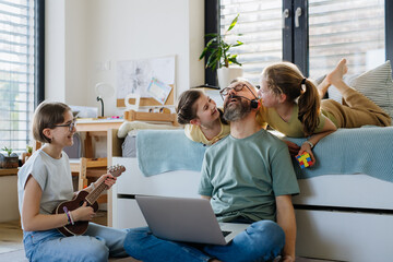 Father with three daughters trying to work from homeoffice.