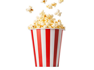 A red and white striped box of popcorn, a tasty movie theater snack, and loose kernels in a glass, all isolated on white.