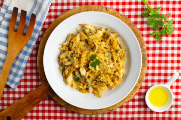 Cod o bras, golden cod with potatoes, a traditional Portuguese dish. Top view table.