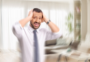 Man loosing his mind holding head