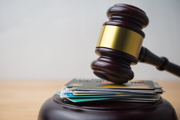 Close up judge hammer gavel on many credit card with white wall background copy space. Financial...