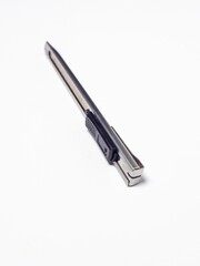 Close-up of a utility knife isolated on a plain white background
