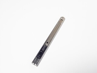Close-up of a silver utility knife isolated on a white background