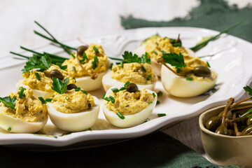 Eggs stuffed with mousse of egg yolk, mayonnaise, mustard and capers.