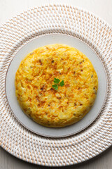 Spanish omelette with potatoes and onion. Top view table.