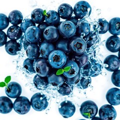 Fresh blueberries glistening with water, a vibrant and healthy snack presented on a white background.