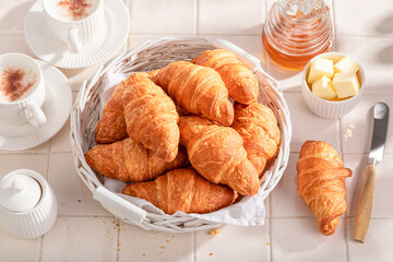 Hot and golden french croissants served with coffee.