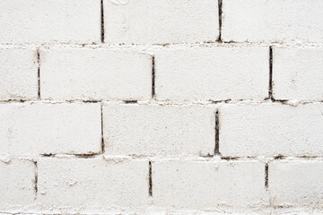 An unplastered concrete block wall painted white