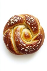 Fototapeta premium Golden brown swirl bun topped with sesame seeds on white minimalist background 