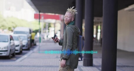 Man standing on sidewalk using smartphone app, displaying audio waveform graphic for technology - Powered by Adobe