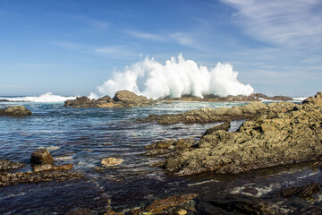 Waves breaking spectacular on the rocky coastline of the Tsitsikamma section of the Garden Route National Park, South Africa.