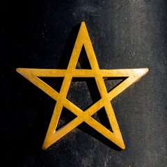Golden pentagram star on a dark background in Marrakesh, Morocco, symbolizing spirituality,...
