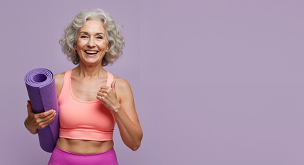 Senior woman with silver hair holding purple yoga mat on lavender background. Smiling active elderly female. Fitness for seniors, healthy aging, active lifestyle. Yoga classes, wellness programs