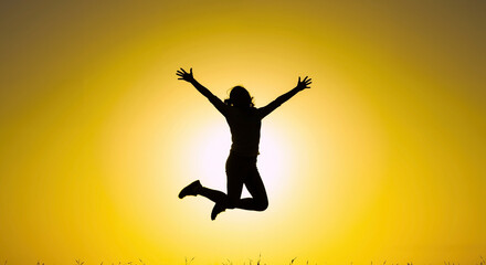 Naklejka premium Silhouette of person jumping with arms outstretched against golden sunset. Human figure leaping with joy at sunrise. Freedom and achievement. motivational, wellness retreats, life coaching services
