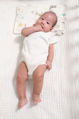 Baby Smiling and Playing in a Crib During Morning Time at Home With Calm Ambiance