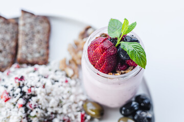 Delicious breakfast plate featuring an omelet, fresh vegetables, and yogurt dessert with berries