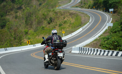 motorcycle on the road rides away. Travel on vacation, enjoy the nature trail. motorcycle in a sunny motorbike on the road riding.with sunset light. copyspace for your individual text..