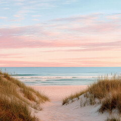 Sand dunes with grass against ocean and sunset sky. Calm sea scene with soft light and pastel colors. Summer, vacation, nature, travel and relaxation.