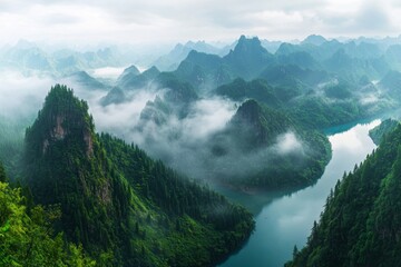 Misty mountain range with a winding river. Lush green landscape