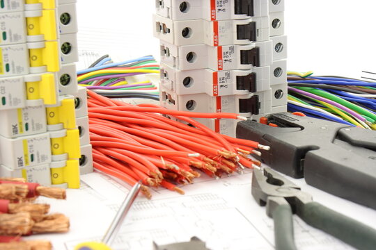 1 Pole Current Circuit Breakers from ABB, IEK during the assembly of the electrical panel. On the electrical diagram. Mounting tools for panel assembly. 